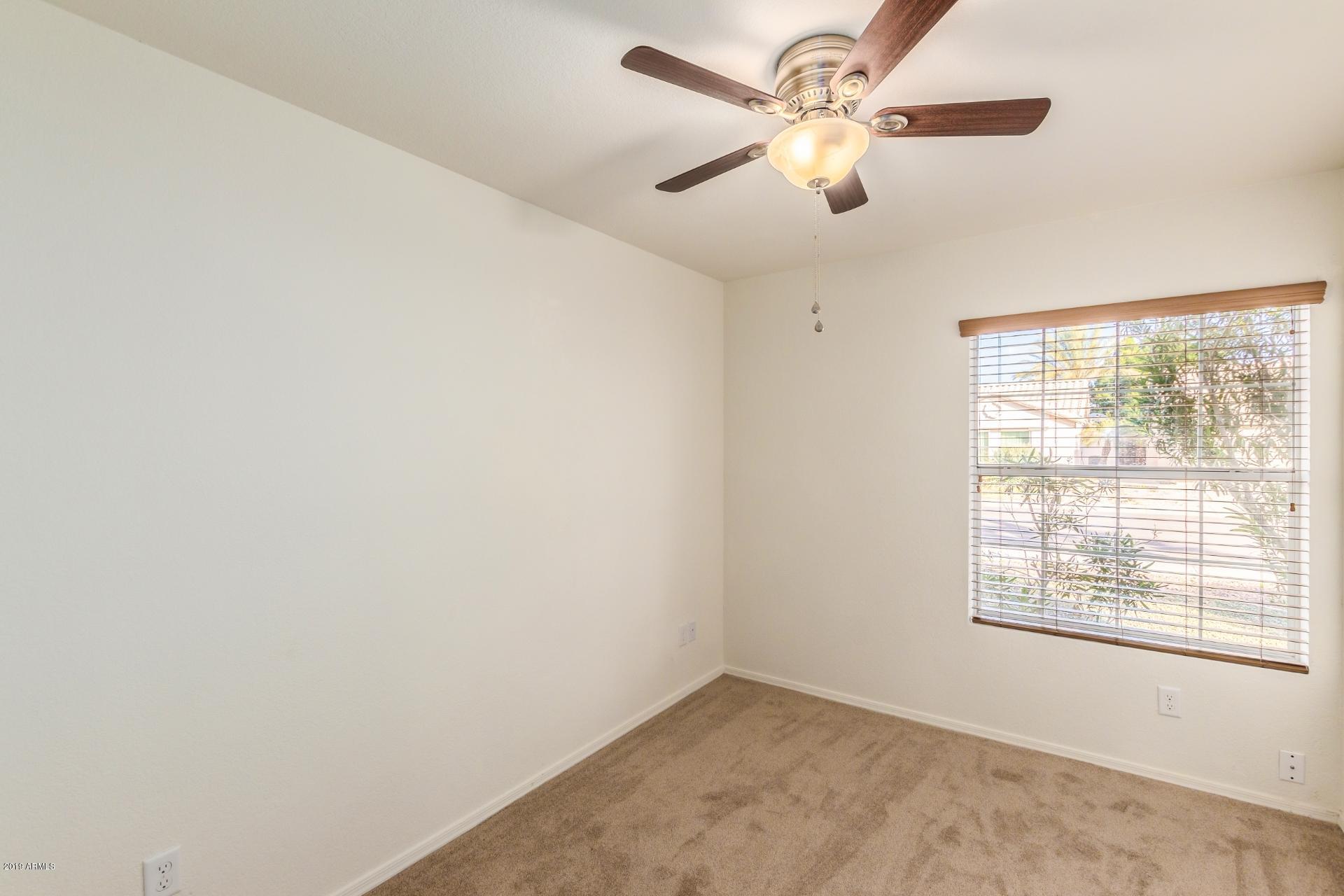 213 West Marco Polo Road Phoenix, AZ 85027 - Photo 18 of 21 an empty room with a window and a fan