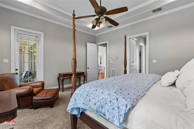 a bedroom with a bed a couch and a dresser