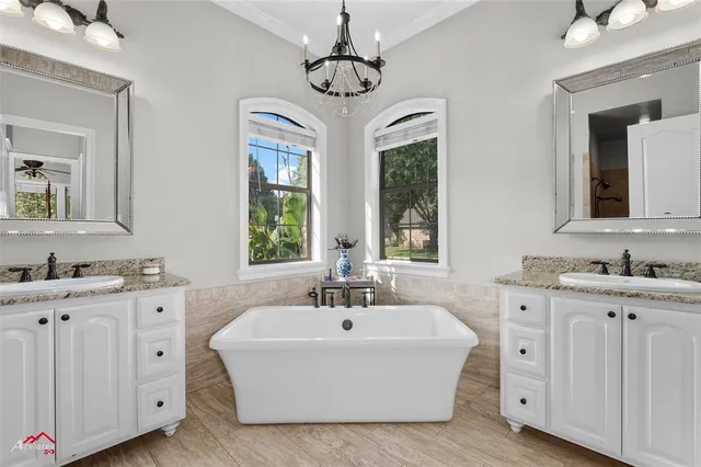 a white bath tub sitting next to a bathroom sink