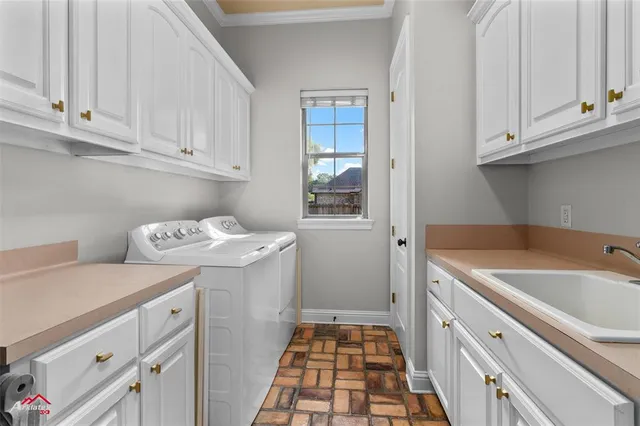 a utility room with sink dryer and washer