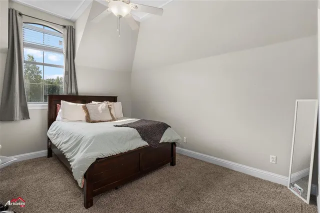 a bedroom with a bed and a table