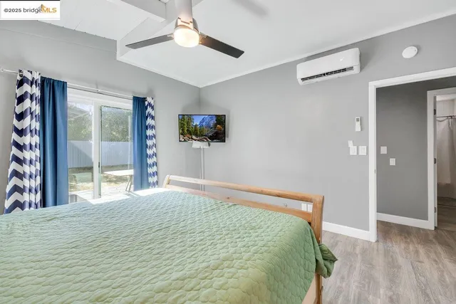 a bedroom with a bed and a large window