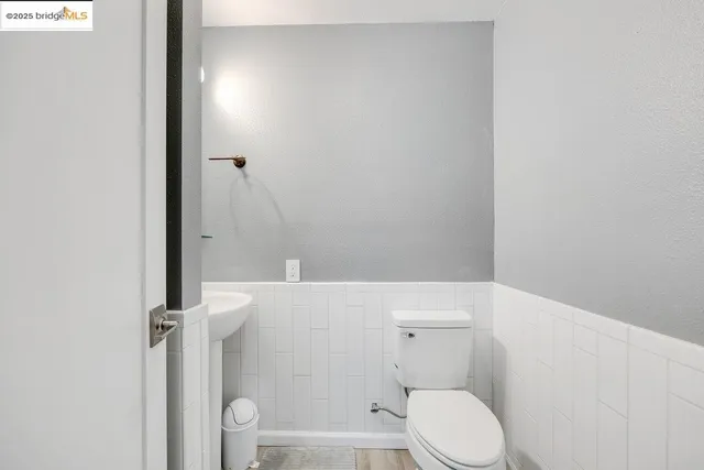 a white toilet sitting next to a shower
