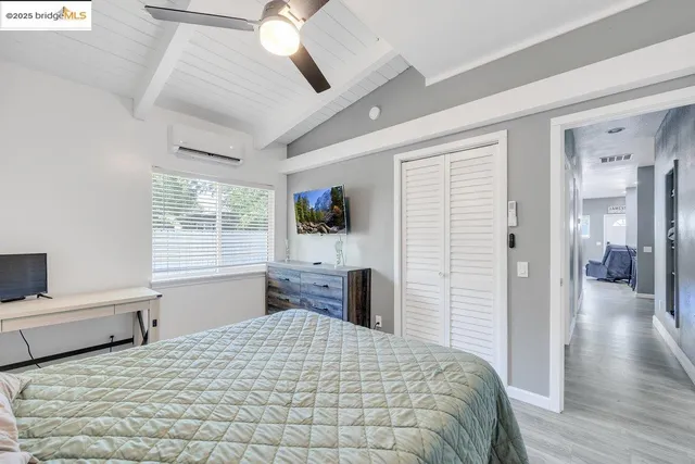 a bedroom with a large bed and a window