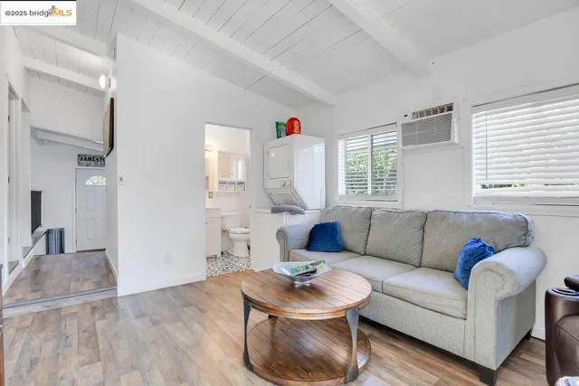 a bedroom with a bed window and a mirror