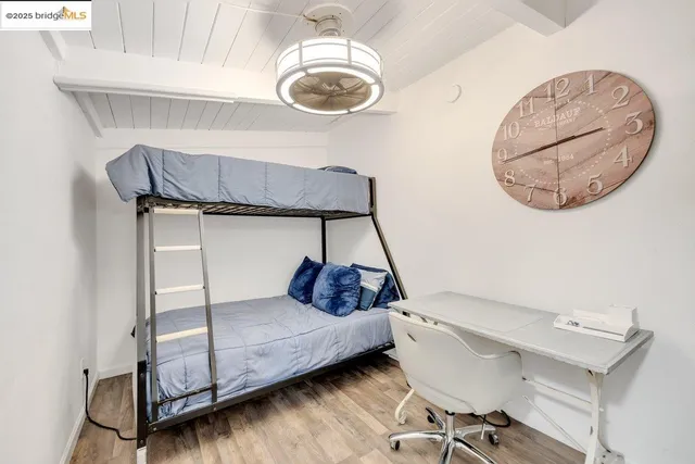 a bedroom with furniture and a flat screen tv