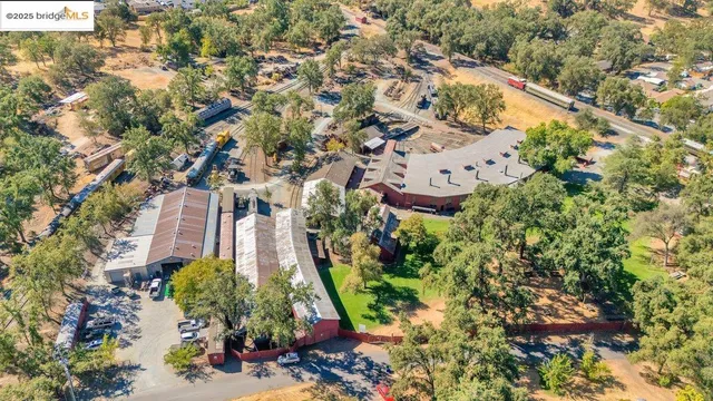 an aerial view of a house with a yard and lake view