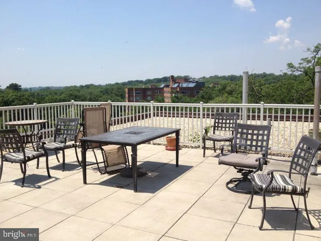a view of a roof deck with furniture