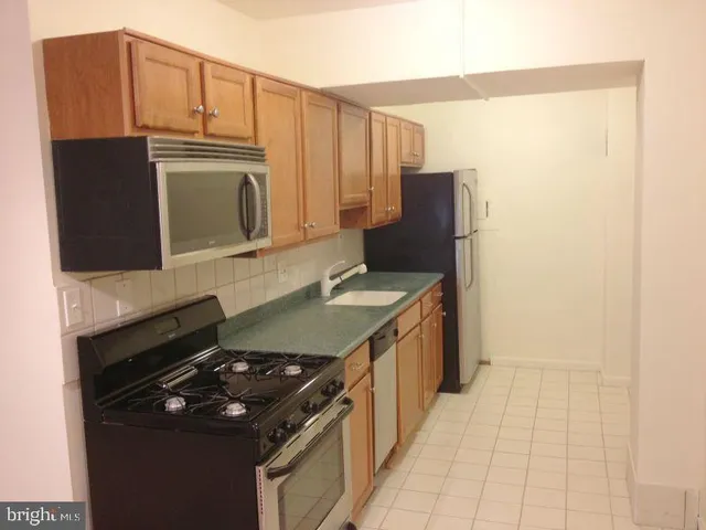 a kitchen with stainless steel appliances granite countertop a stove and a microwave