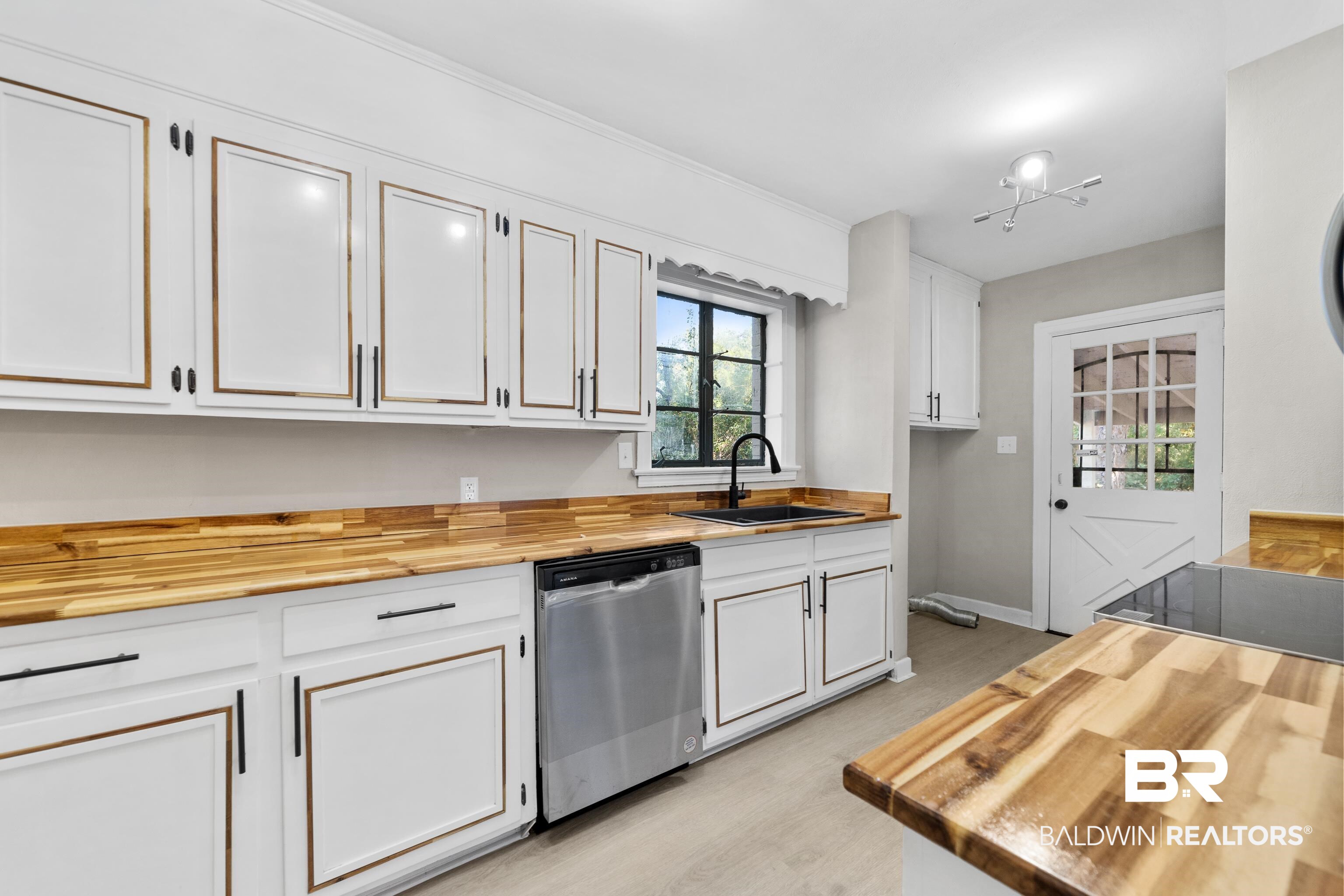 611 Morgan Avenue Mobile, AL 36606 - Photo 12 of 24 Kitchen with white cabinetry, butcher block counters, stainless steel dishwasher, and sink