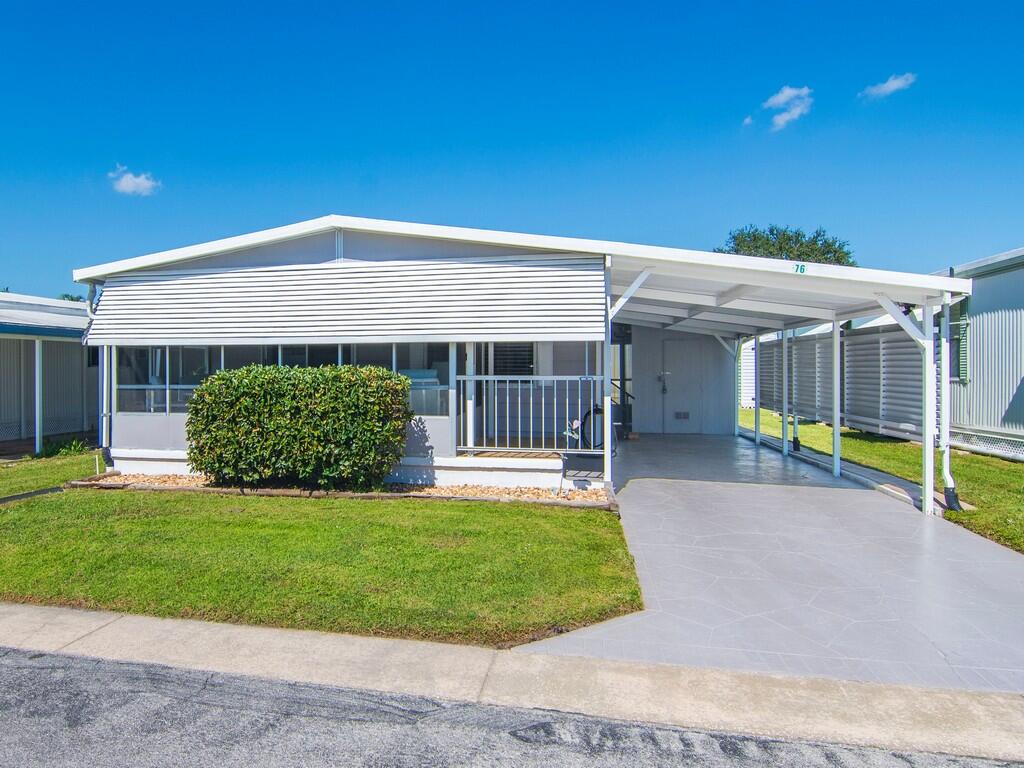 a view of an house with backyard porch and furniture