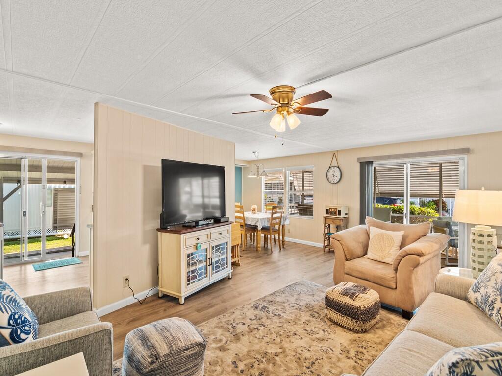 4800 Southeast Federal Highway, Unit 76 Stuart, FL 34997 - Photo 11 of 32 a living room with furniture and a flat screen tv