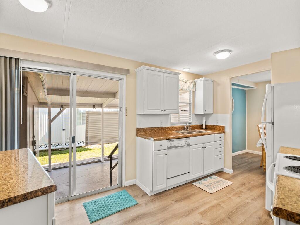 4800 Southeast Federal Highway, Unit 76 Stuart, FL 34997 - Photo 12 of 32 a large kitchen with a window and a sink