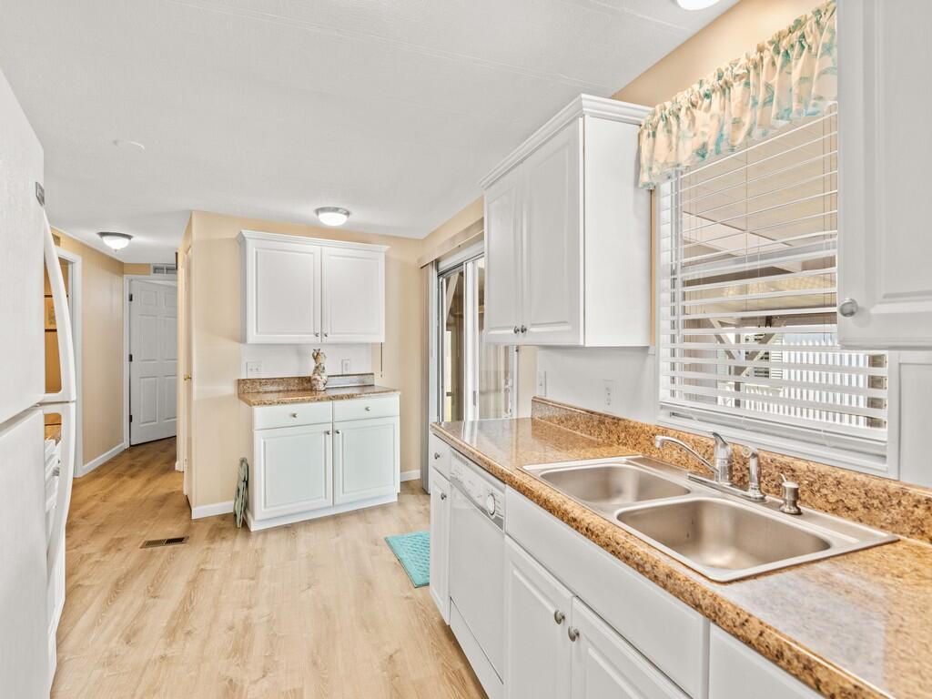 4800 Southeast Federal Highway, Unit 76 Stuart, FL 34997 - Photo 14 of 32 a kitchen with a sink cabinets and window
