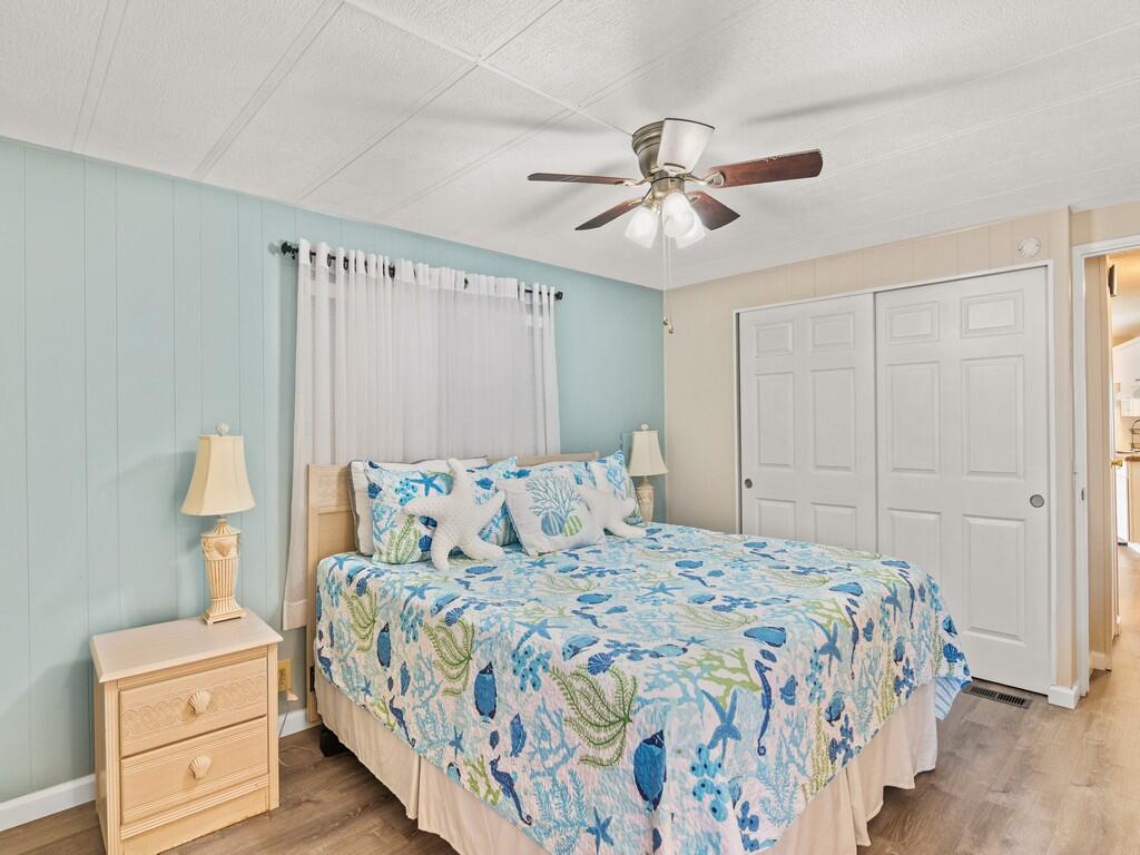 4800 Southeast Federal Highway, Unit 76 Stuart, FL 34997 - Photo 19 of 32 a bedroom with a bed and a closet