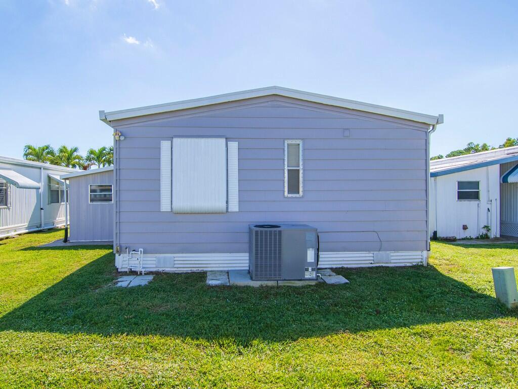 4800 Southeast Federal Highway, Unit 76 Stuart, FL 34997 - Photo 28 of 32 a view of a house with a backyard