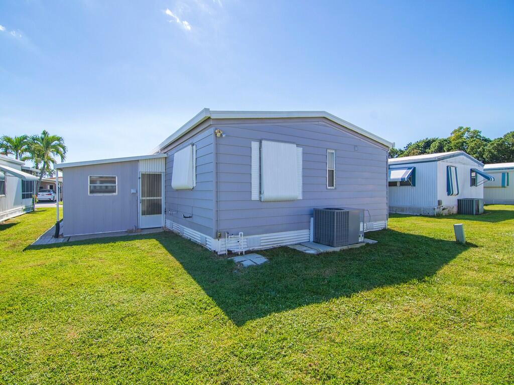 4800 Southeast Federal Highway, Unit 76 Stuart, FL 34997 - Photo 29 of 32 a view of a house with a yard