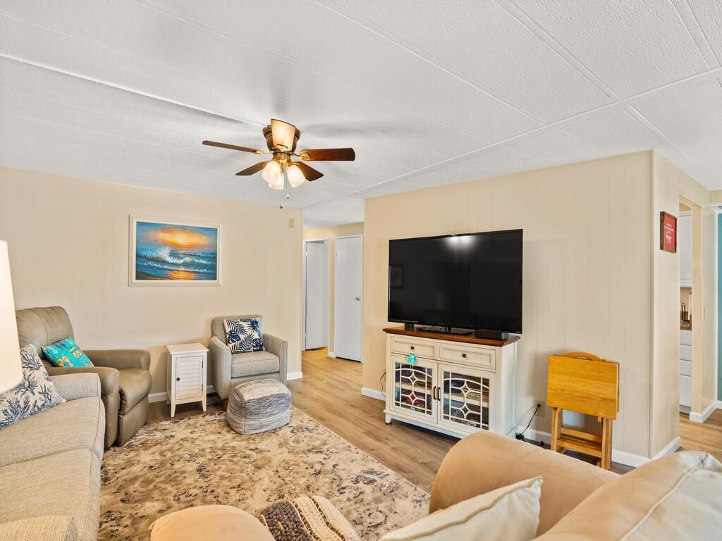 4800 Southeast Federal Highway, Unit 76 Stuart, FL 34997 - Photo 9 of 32 a living room with furniture and a flat screen tv