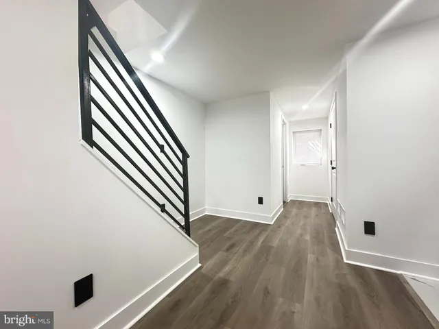 an entryway in a hall with wooden floor