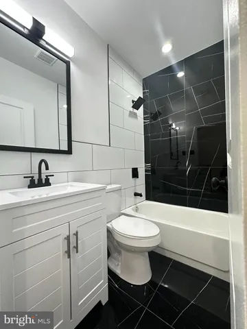 a bathroom with a sink toilet a mirror and shower