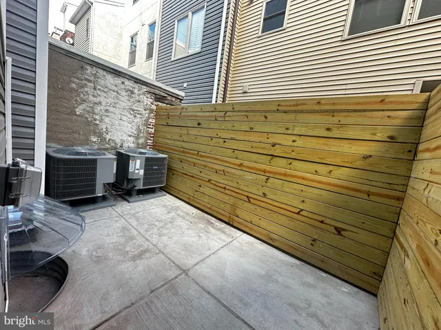 a view of a chair and tables in the back yard of a house