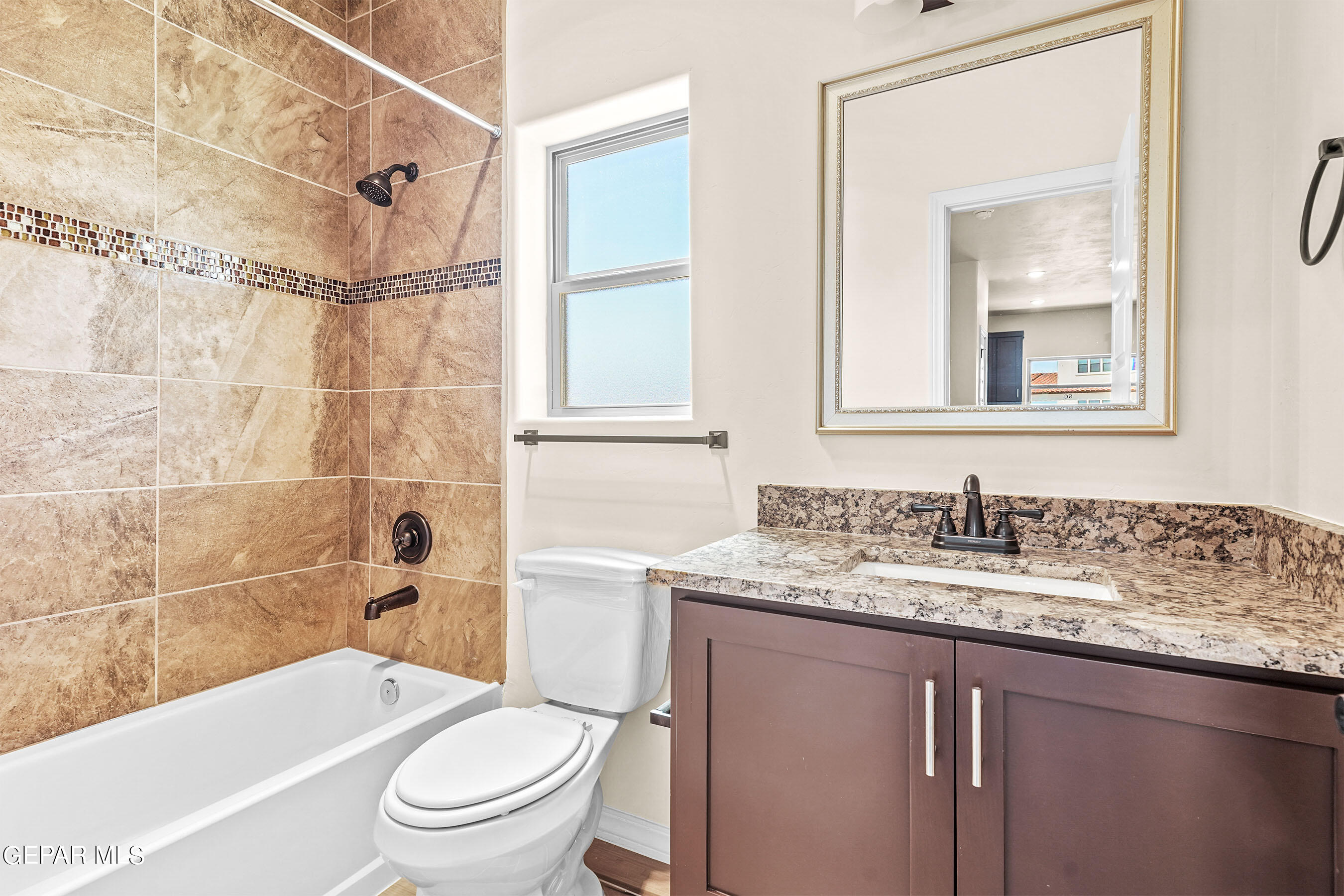 871 Country Club Road, Unit 4E El Paso, TX 79932 - Photo 22 of 34 a bathroom with a granite countertop toilet a sink and a bathtub