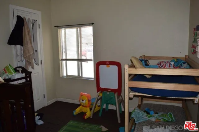 a bench sitting in a bedroom next to a window