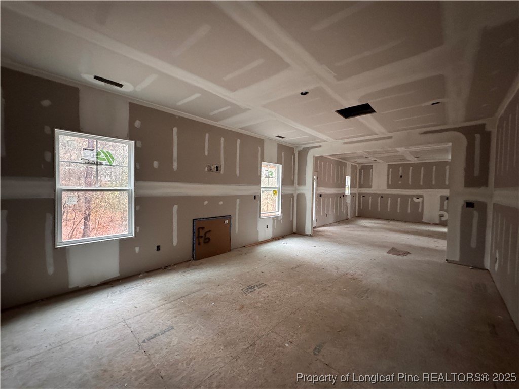 428 Redwater Trail Aberdeen, NC 28315 - Photo 12 of 48 a view of an empty room with a fireplace and a window