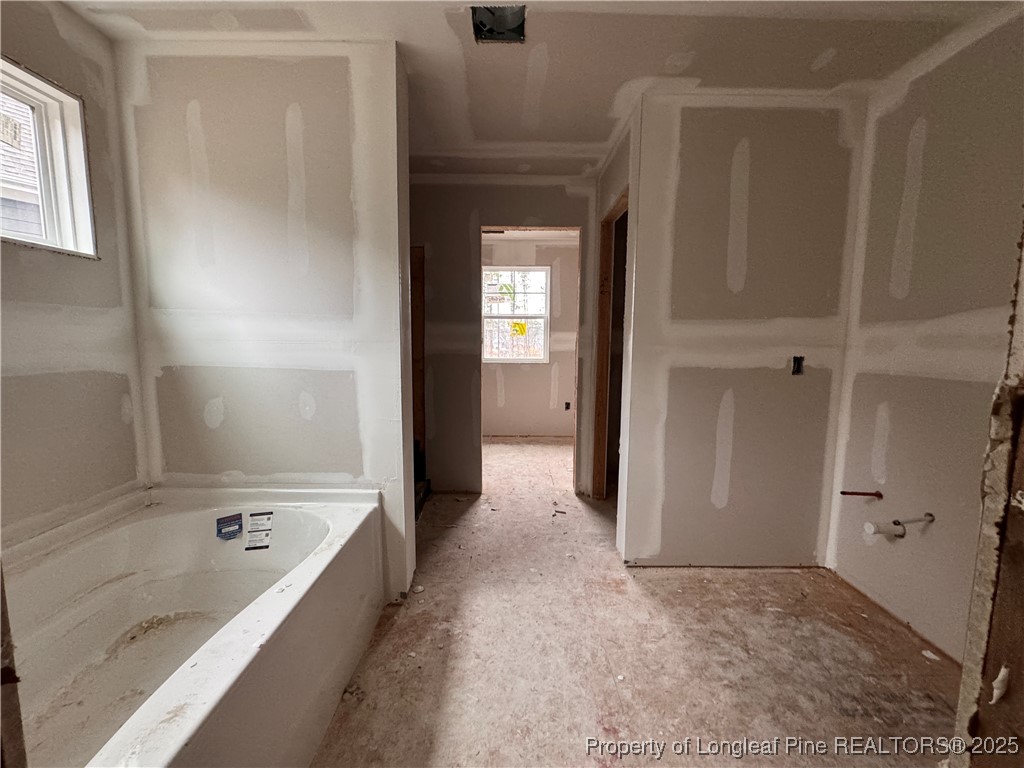428 Redwater Trail Aberdeen, NC 28315 - Photo 19 of 48 a bathroom with a tub a sink and a large mirror