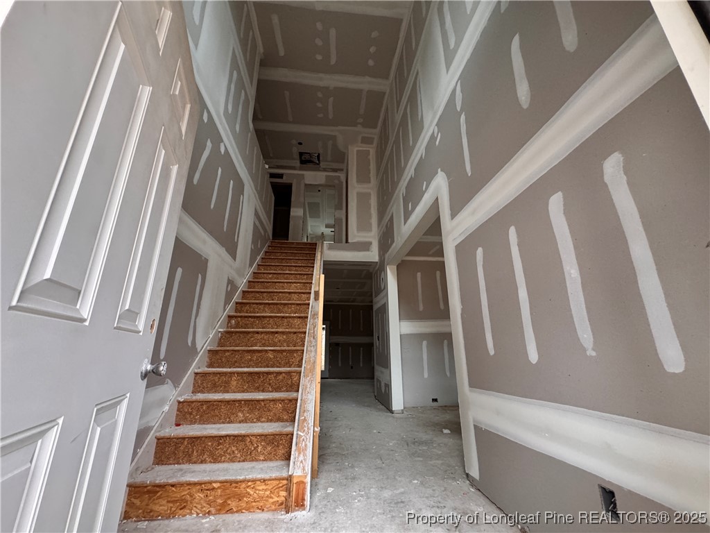 428 Redwater Trail Aberdeen, NC 28315 - Photo 5 of 48 a view of staircase with white walls and a rug