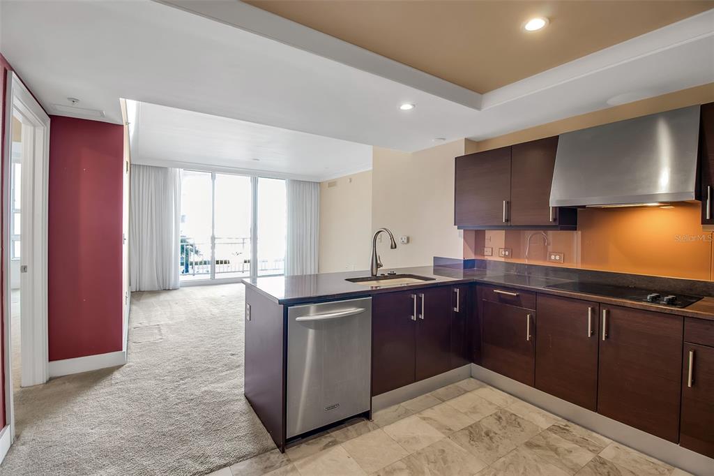 1350 Main Street, Unit 707 Sarasota, FL 34236 - Photo 12 of 68 a kitchen with stainless steel appliances granite countertop a sink stove and cabinets