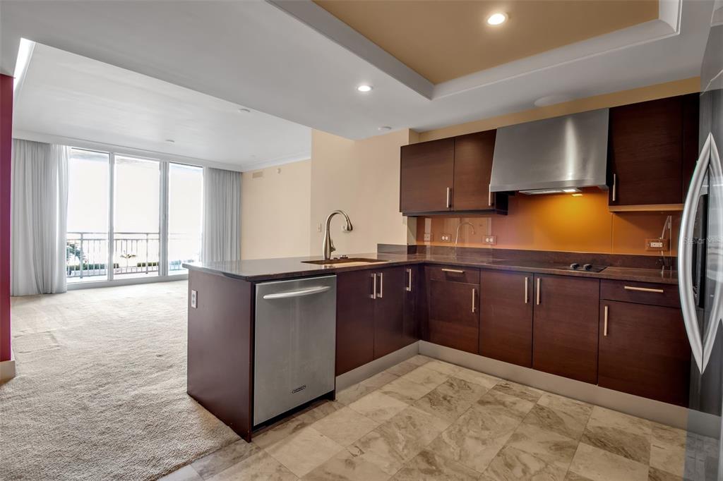 1350 Main Street, Unit 707 Sarasota, FL 34236 - Photo 13 of 68 a kitchen with stainless steel appliances granite countertop a stove a sink and a refrigerator