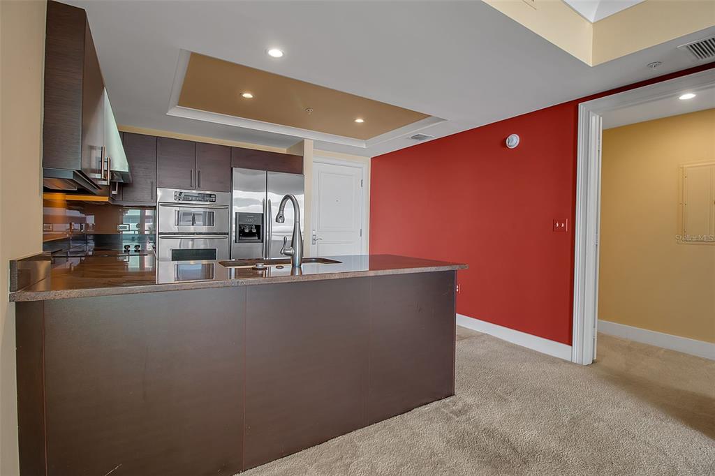 1350 Main Street, Unit 707 Sarasota, FL 34236 - Photo 15 of 68 a living room with stainless steel appliances with kitchen view