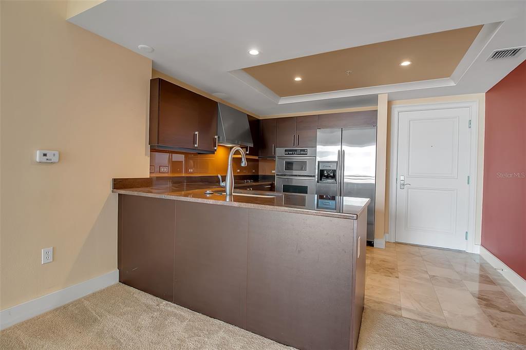 1350 Main Street, Unit 707 Sarasota, FL 34236 - Photo 16 of 68 a kitchen with stainless steel appliances a refrigerator and a stove top oven