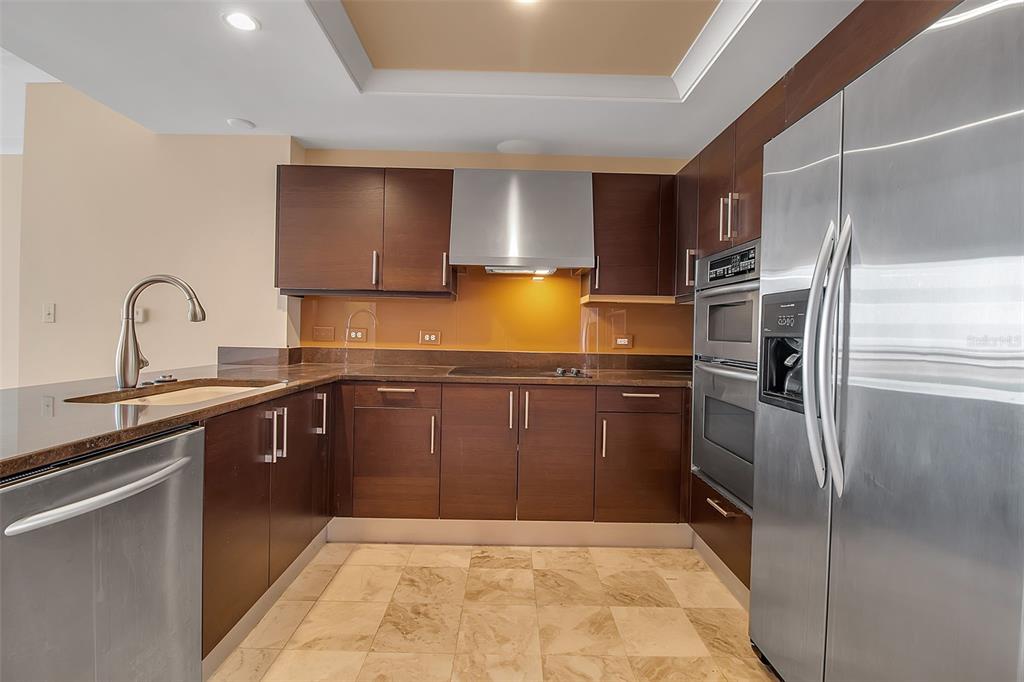 1350 Main Street, Unit 707 Sarasota, FL 34236 - Photo 17 of 68 a kitchen with a sink refrigerator and cabinets