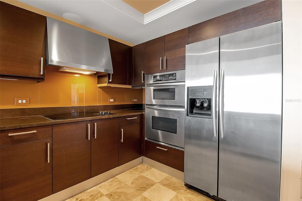 1350 Main Street, Unit 707 Sarasota, FL 34236 - Photo 18 of 68 a kitchen with stainless steel appliances granite countertop a refrigerator and a stove