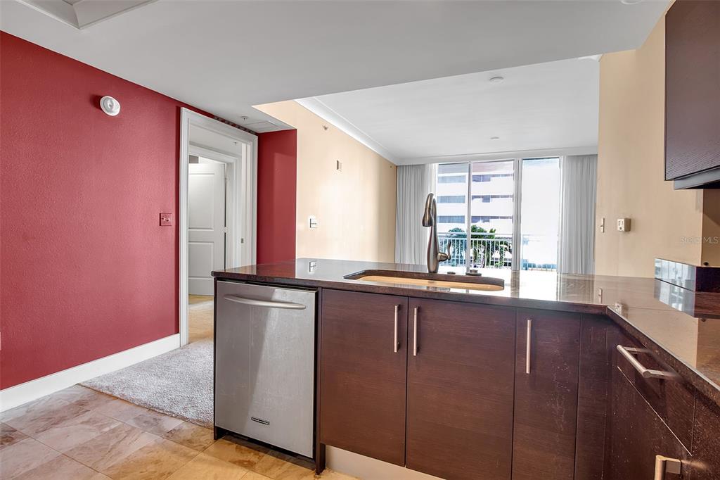 1350 Main Street, Unit 707 Sarasota, FL 34236 - Photo 19 of 68 a kitchen with stainless steel appliances granite countertop a sink a stove and a refrigerator
