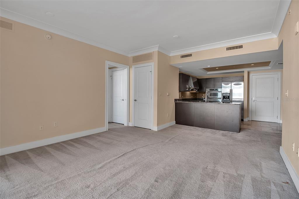 1350 Main Street, Unit 707 Sarasota, FL 34236 - Photo 21 of 68 a view of a livingroom with wooden floor and kitchen space with a sink