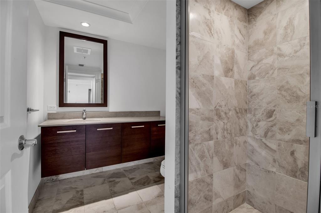 1350 Main Street, Unit 707 Sarasota, FL 34236 - Photo 28 of 68 a bathroom with a granite countertop sink and a mirror