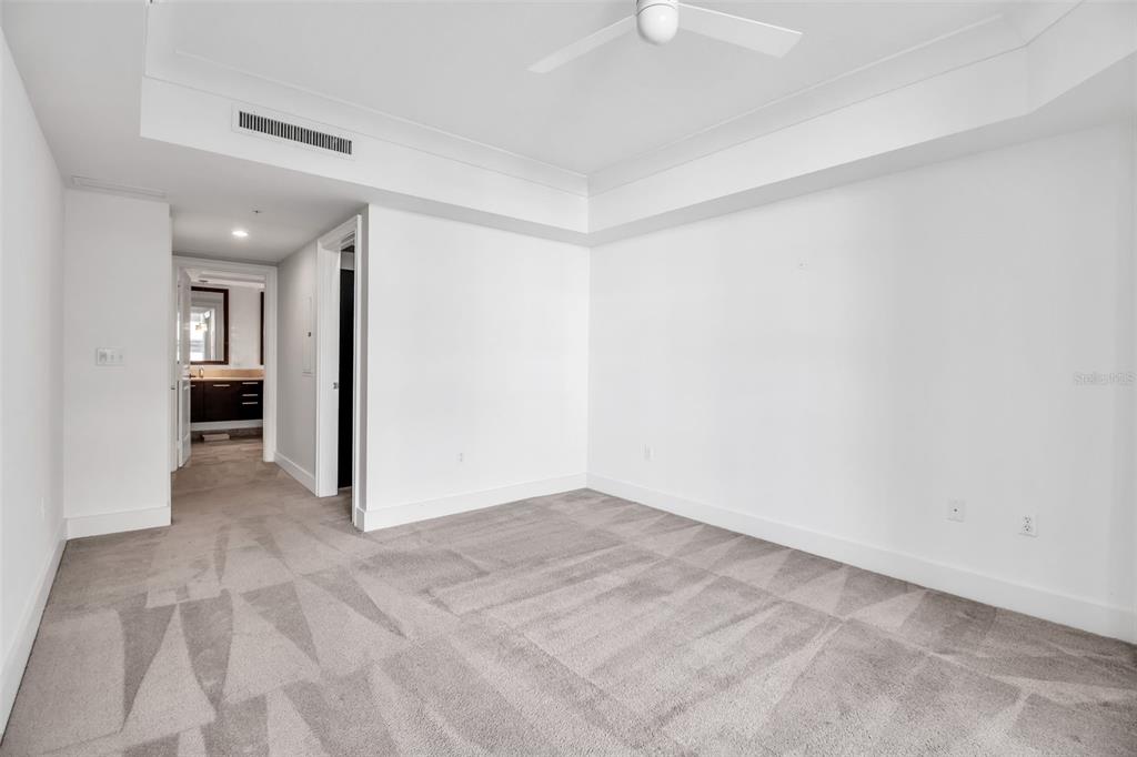 1350 Main Street, Unit 707 Sarasota, FL 34236 - Photo 33 of 68 an empty room with kitchen view and wooden floor