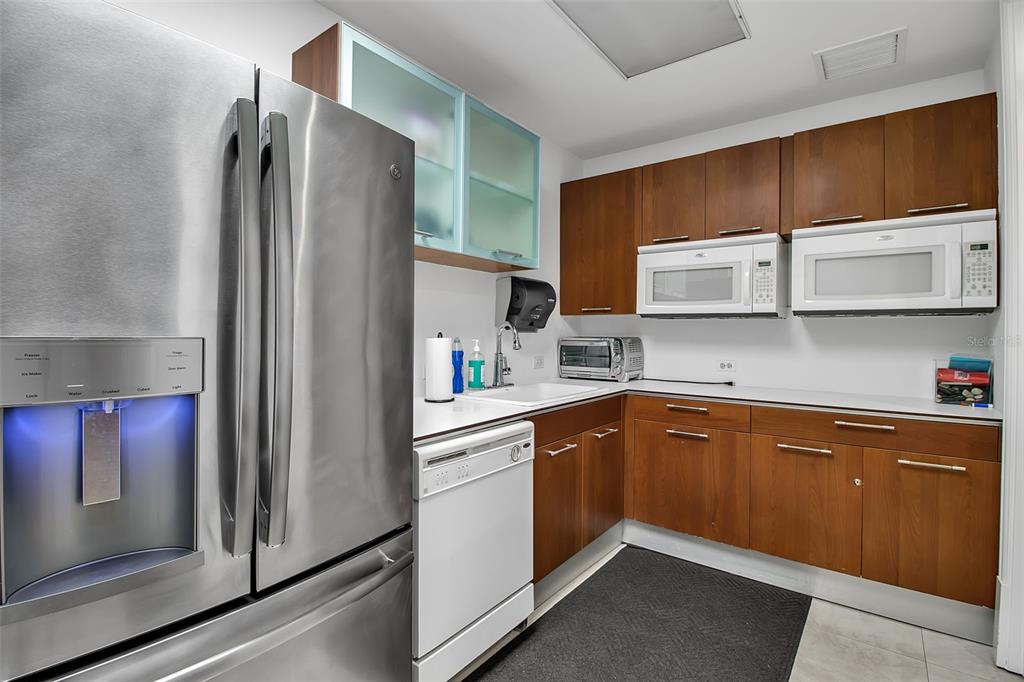 1350 Main Street, Unit 707 Sarasota, FL 34236 - Photo 56 of 68 a kitchen with stainless steel appliances granite countertop a refrigerator and a sink