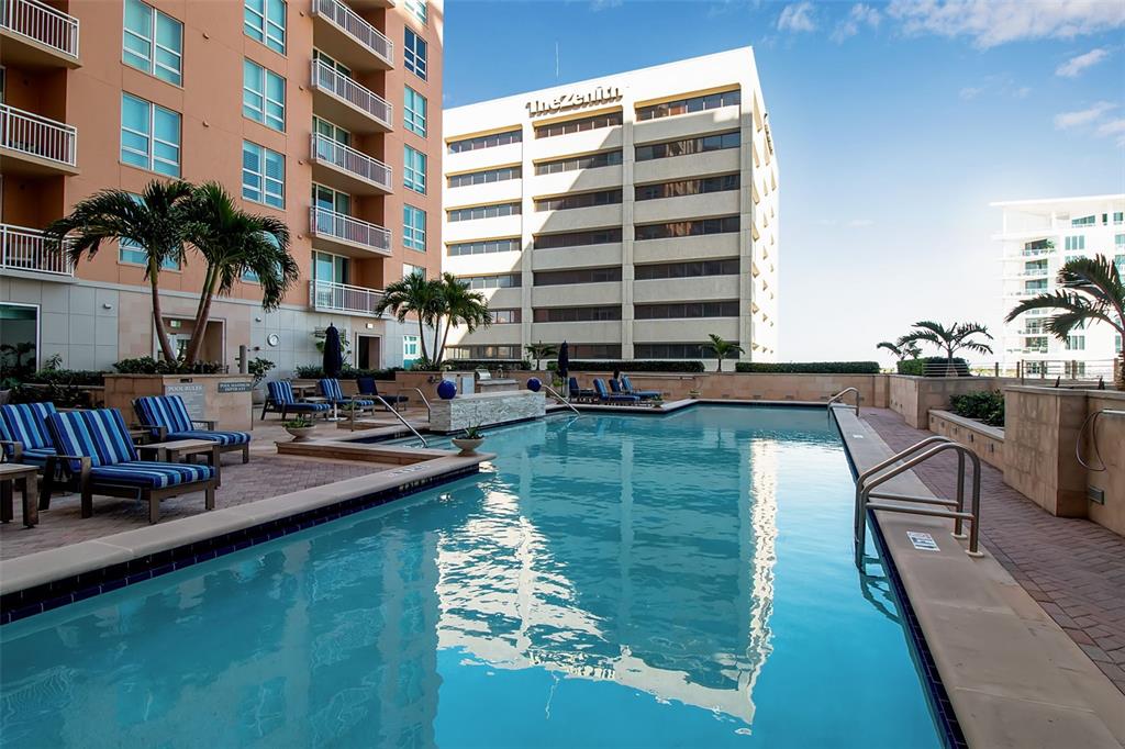 1350 Main Street, Unit 707 Sarasota, FL 34236 - Photo 59 of 68 a swimming pool with outdoor seating and plants