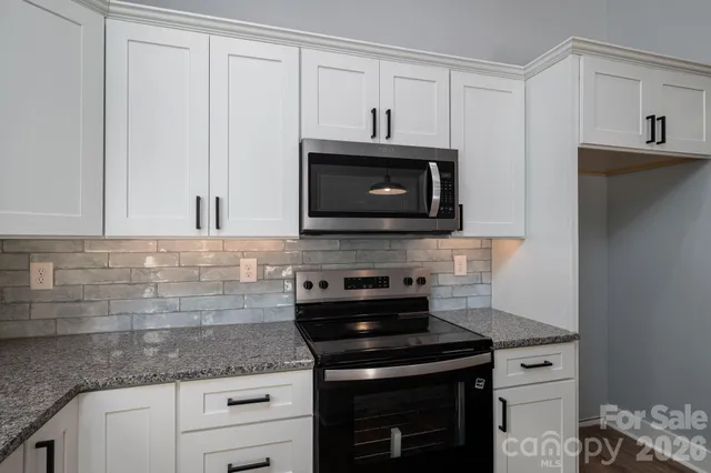 a kitchen with granite countertop a sink and a window