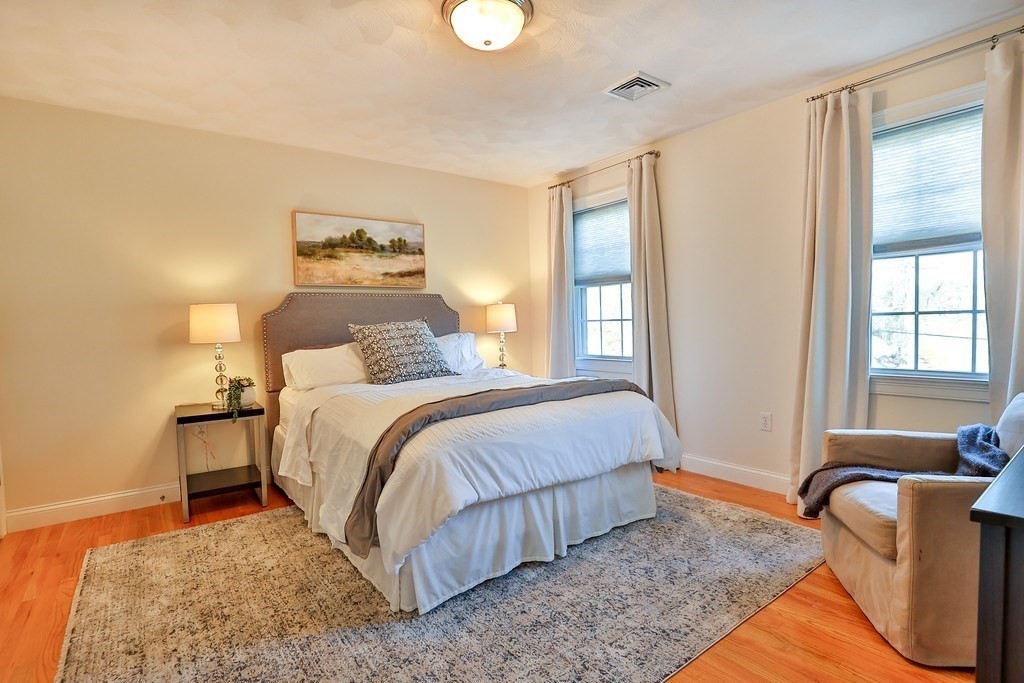 2 Estey Road North Billerica, MA 01862 - Photo 23 of 36 a bedroom with a bed and wooden floor