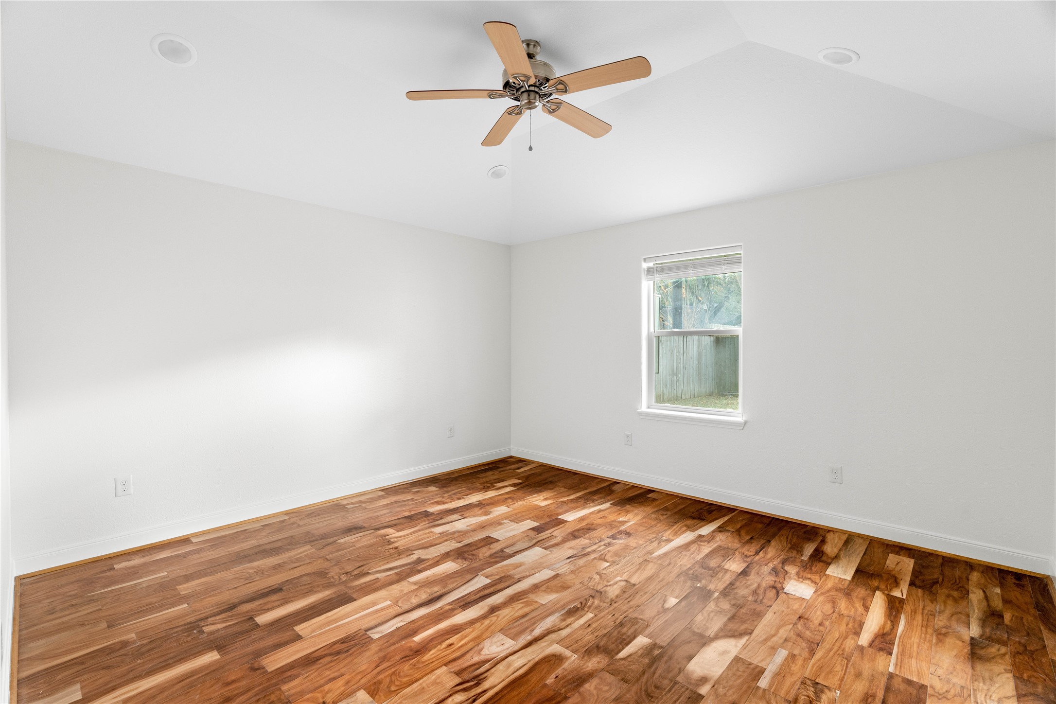 5515 Warm Springs Road Houston, TX 77035 - Photo 12 of 19 an empty room with a window and a ceiling fan
