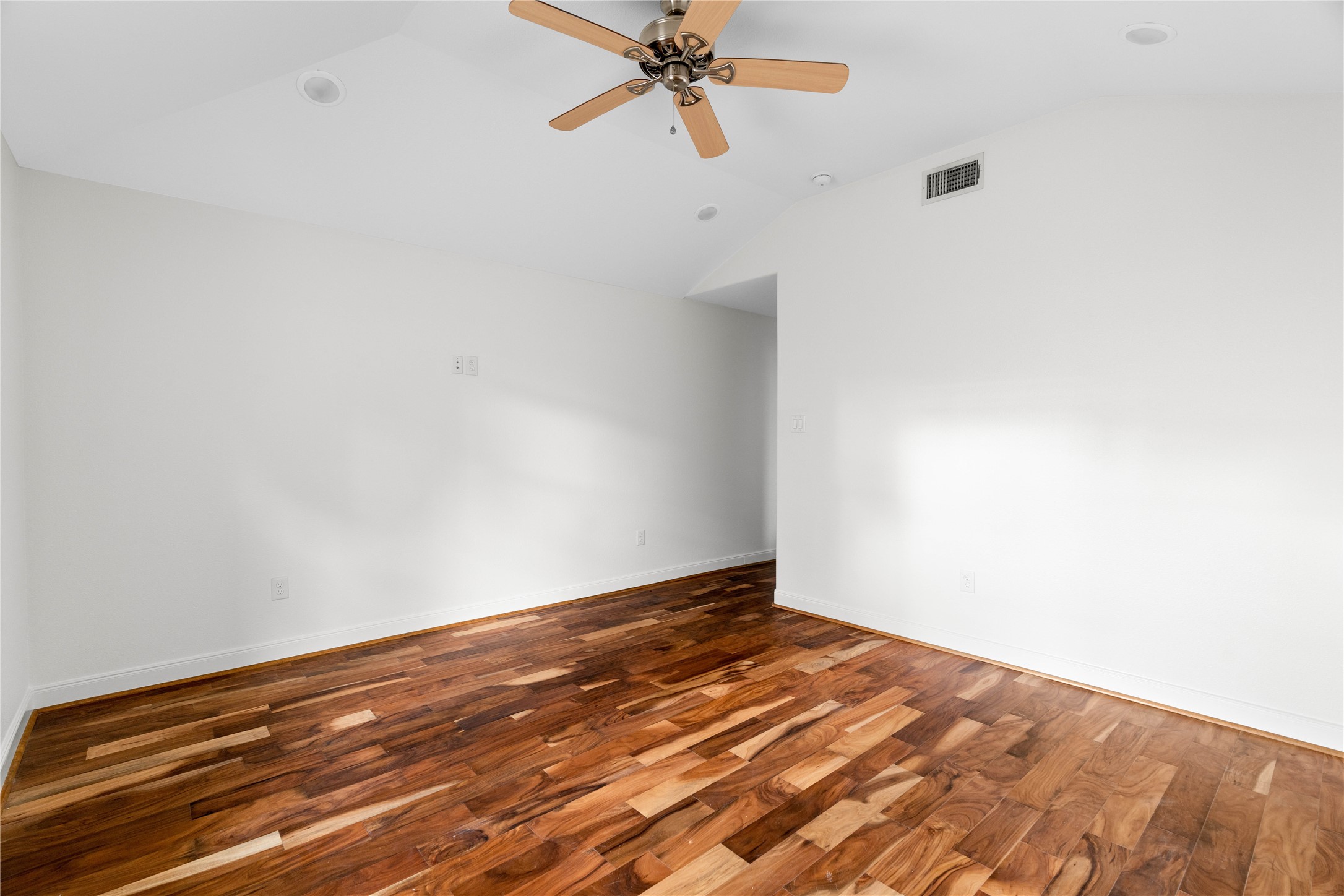 5515 Warm Springs Road Houston, TX 77035 - Photo 13 of 19 a view of a room with wooden floor and a ceiling fan