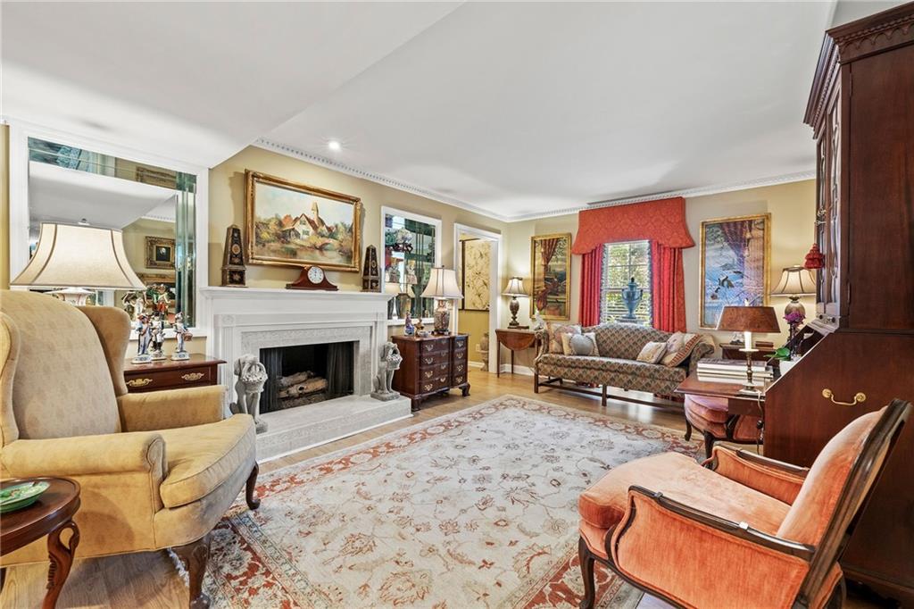 a living room with furniture large window and a fireplace
