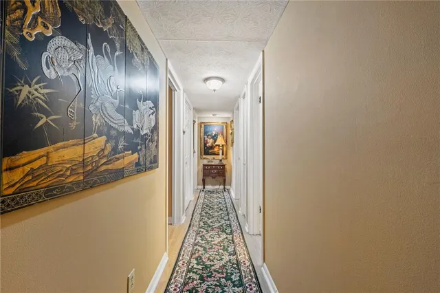 a view of hallway with wooden floor