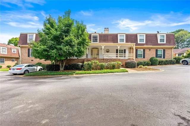 a front view of a house with a yard and a garage