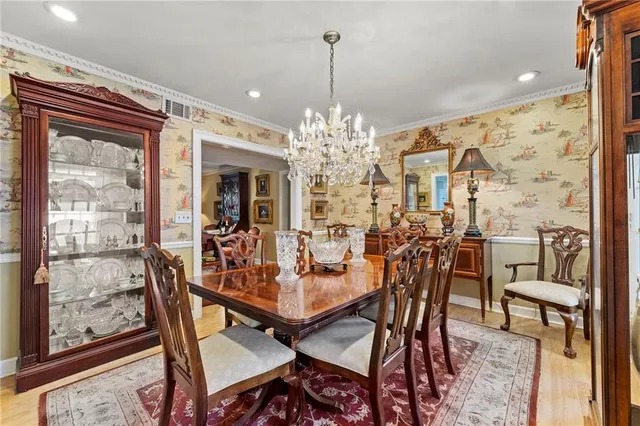 a view of a dining room with furniture and chandelier